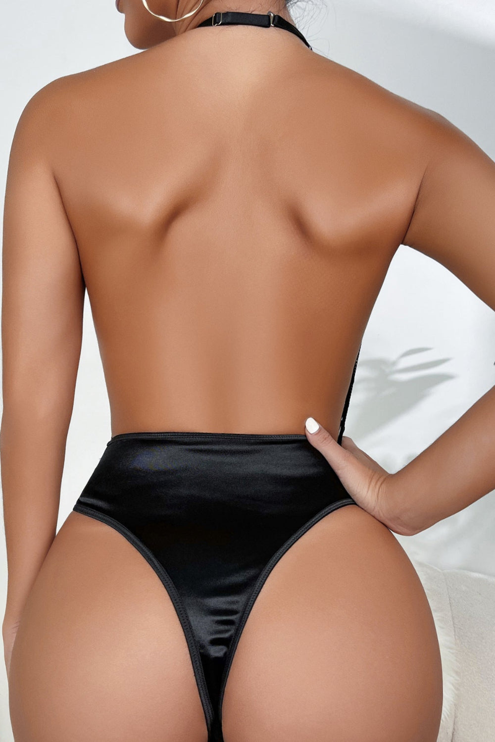 Women's black sexy faux leather grid mesh lingerie bodysuit, deep V halter neck teddy with garter detail